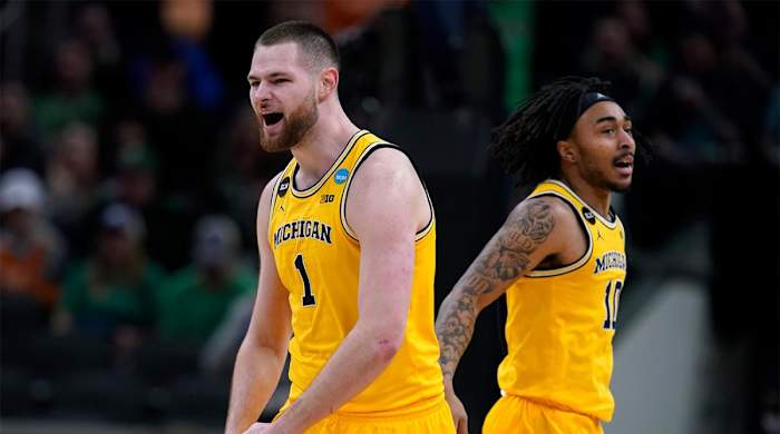 Michigan center Hunter Dickinson (1) celebrates with teammate Frankie Collins, right, during the second half of a college basketball game against Colorado State in the first round of the NCAA tournament in Indianapolis, Thursday, March 17, 2022.
